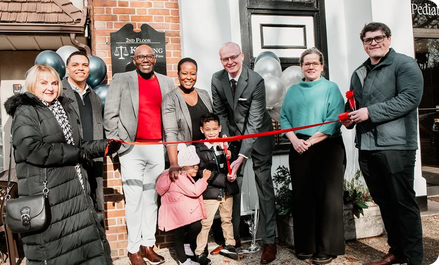 A group of people gathers outside a building